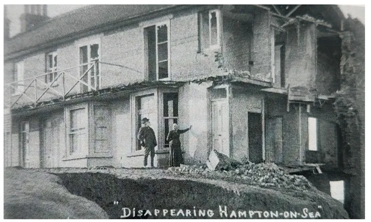 Disappearing 'Hampton-on-sea': black and white image showing two people pointing at a building destroyed by erosion